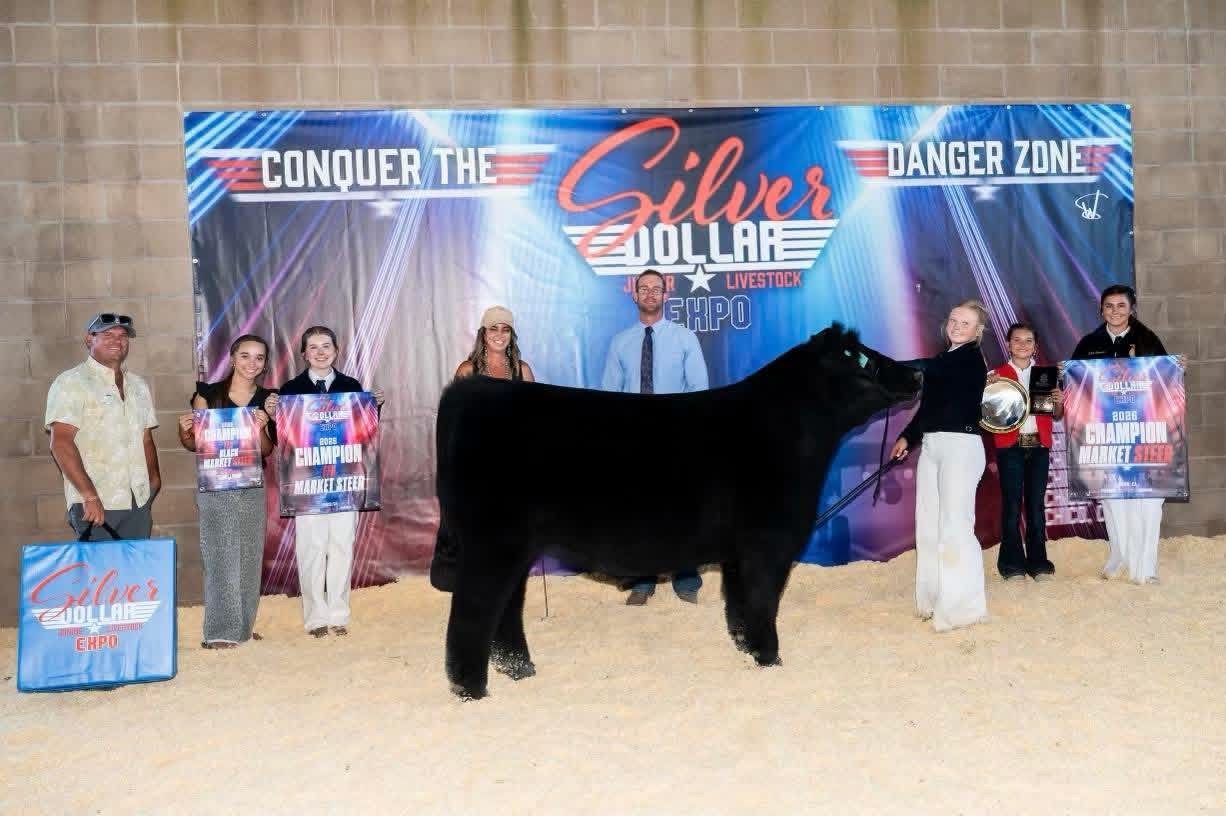 Raegan Johnson with the champion market steer at the 2026 Silver Dollar Fair, sired by HIA out of Maternal Made